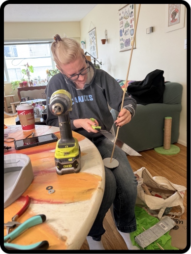 Team member drilling the CuePo base with a Ryobi drill